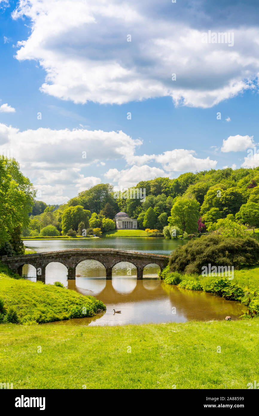 Looking across the lake with its Palladian Bridge towards the Pantheon at Stourhead Gardens, Wiltshire, England, UK Stock Photo