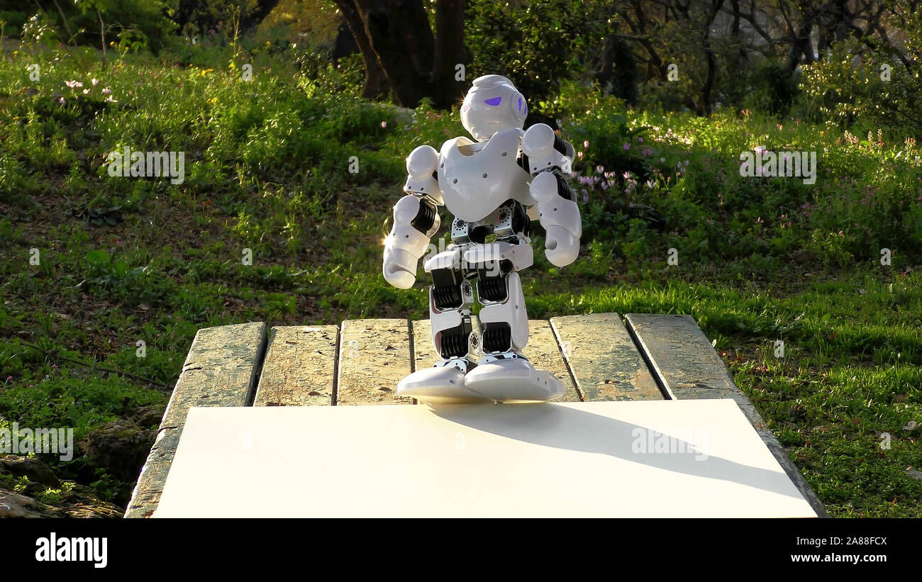 An android humanoid robot is going to teach gymnastics the park. Robot  falls from the mattress Stock Photo - Alamy