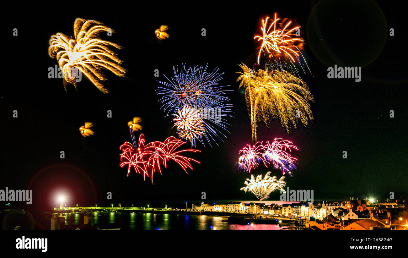 Fireworks display at Donaghadee, County Down, Northern Ireland. Viewed from The Moat overlooking the harbour. Stock Photo