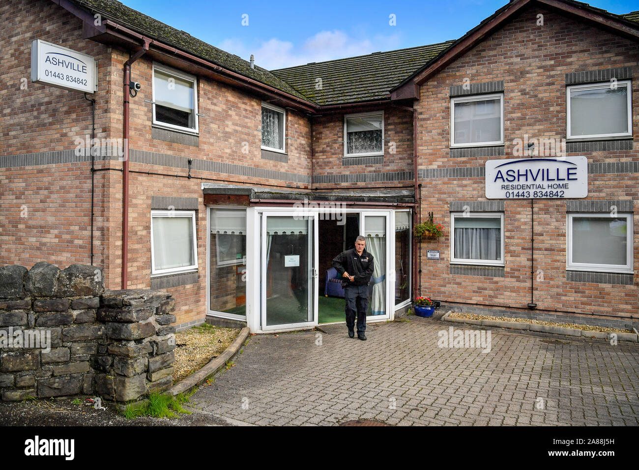 A police officer stands outside Ashville Residential Care Home in
