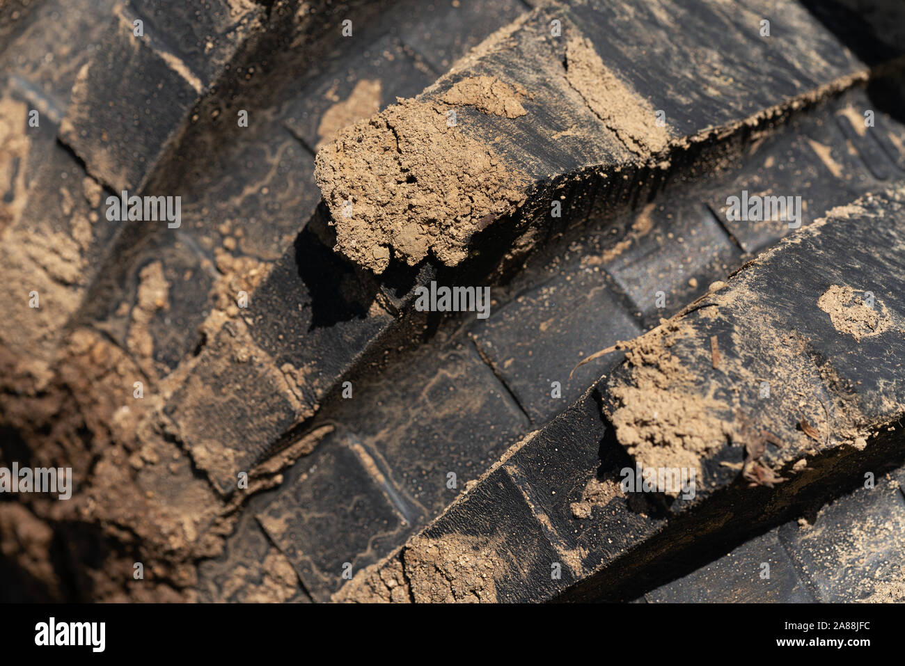 Close-up view of old used rubber mud terrain tire with worn wear ...