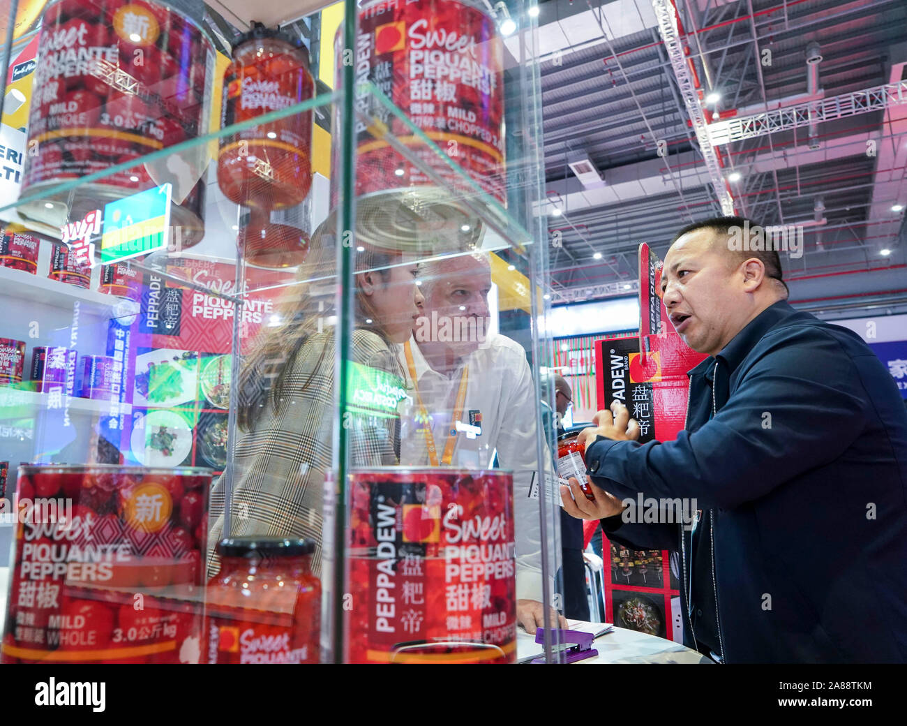 (191107) -- SHANGHAI, Nov. 7, 2019 (Xinhua) -- A visitor (R) talks with staff members at the South Africa pavilion during the second China International Import Expo (CIIE) in Shanghai, east China, Nov. 7, 2019. (Xinhua/Yin Gang) Stock Photo