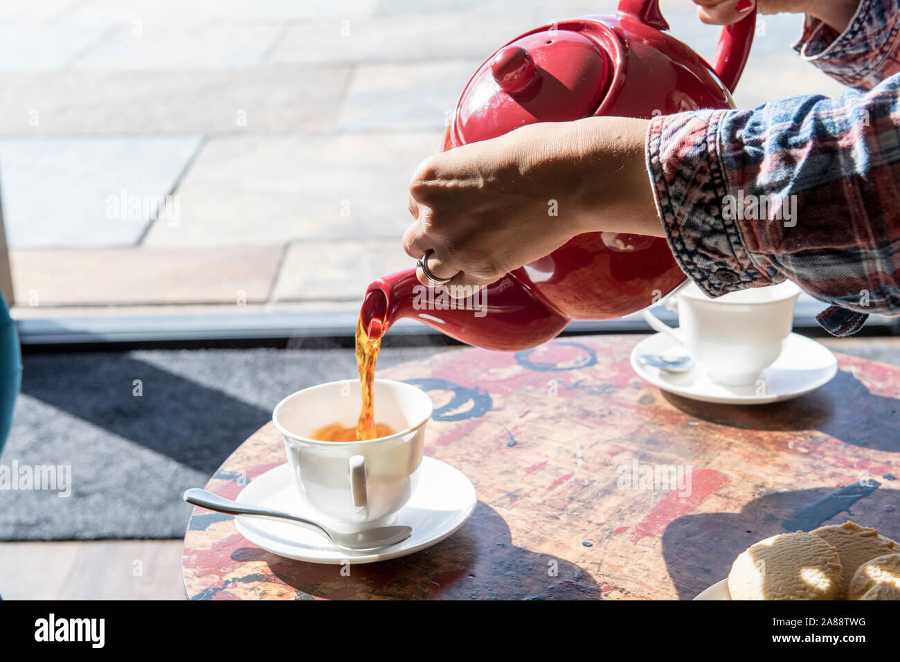 Tea time Pouring English tea from a teapot cup of tea Stock Photo Alamy