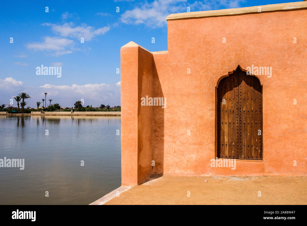 Morocco, Marrakesh. The Menara, a vast garden with olive trees planted under the Almohad Dynasty. At the foot of a pavillon, a pond supplied with wate Stock Photo
