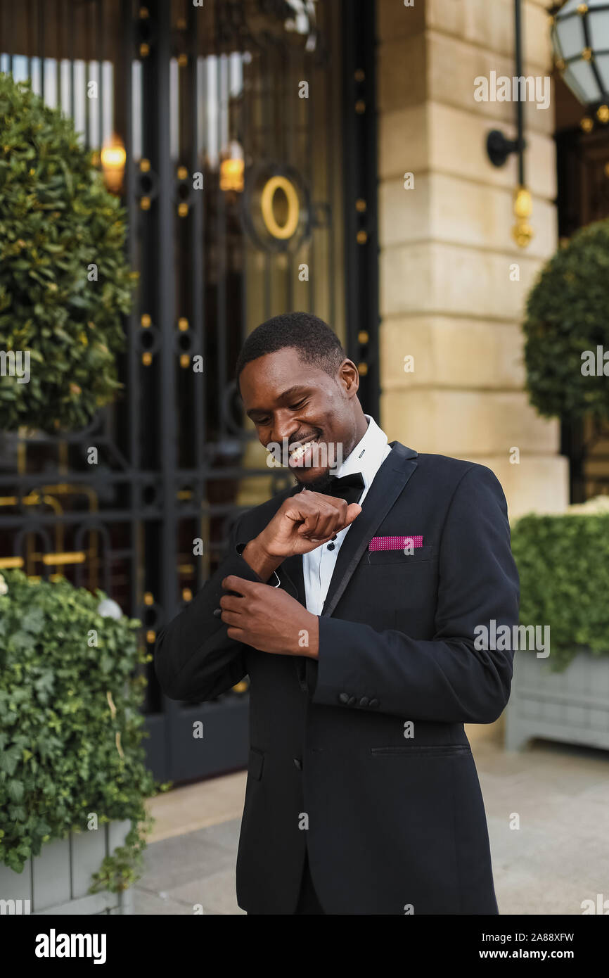 Afro american happy good looking man wearing suit and smiling outdoors ...