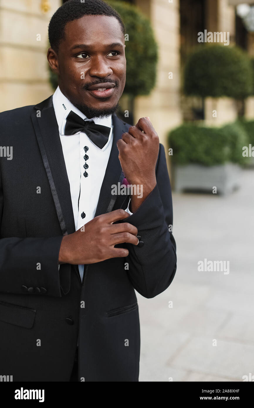 Afro american happy good looking man wearing suit and smiling outdoors ...