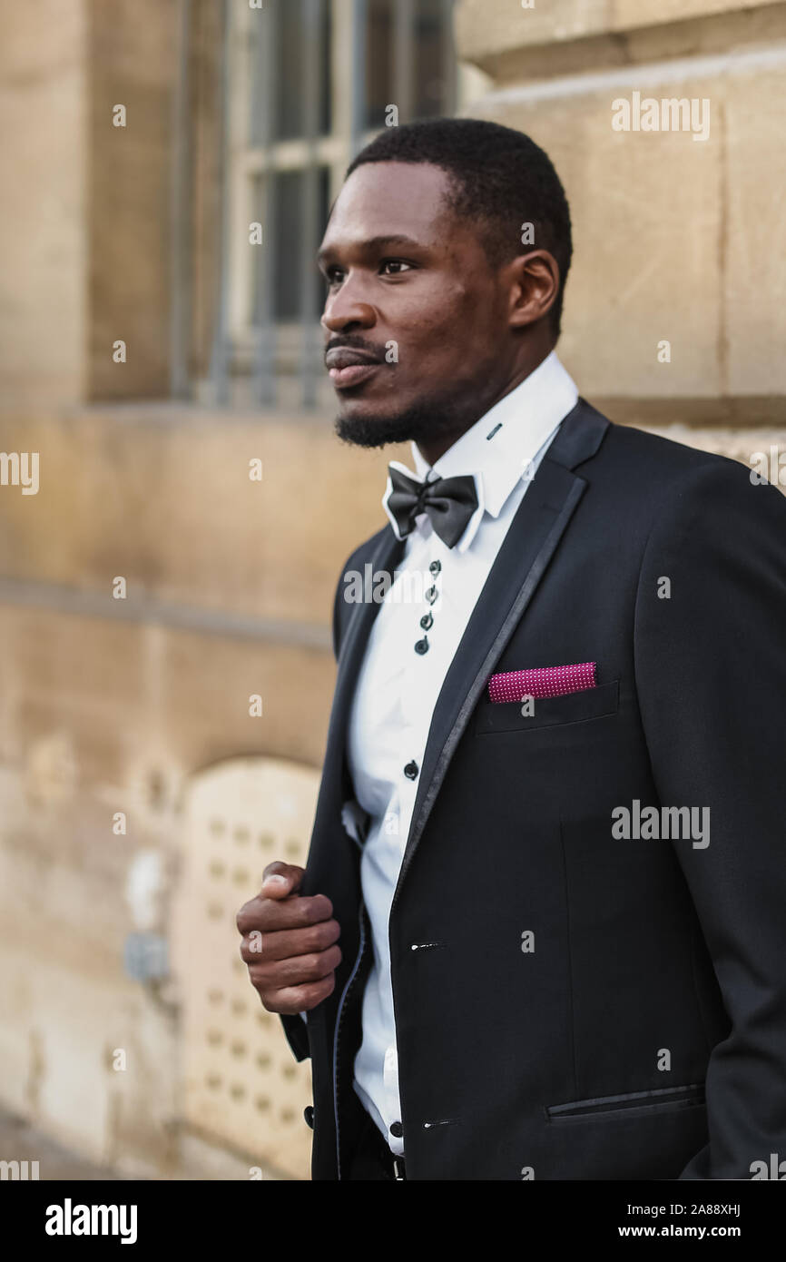 Afro american happy good looking man wearing suit and smiling outdoors ...