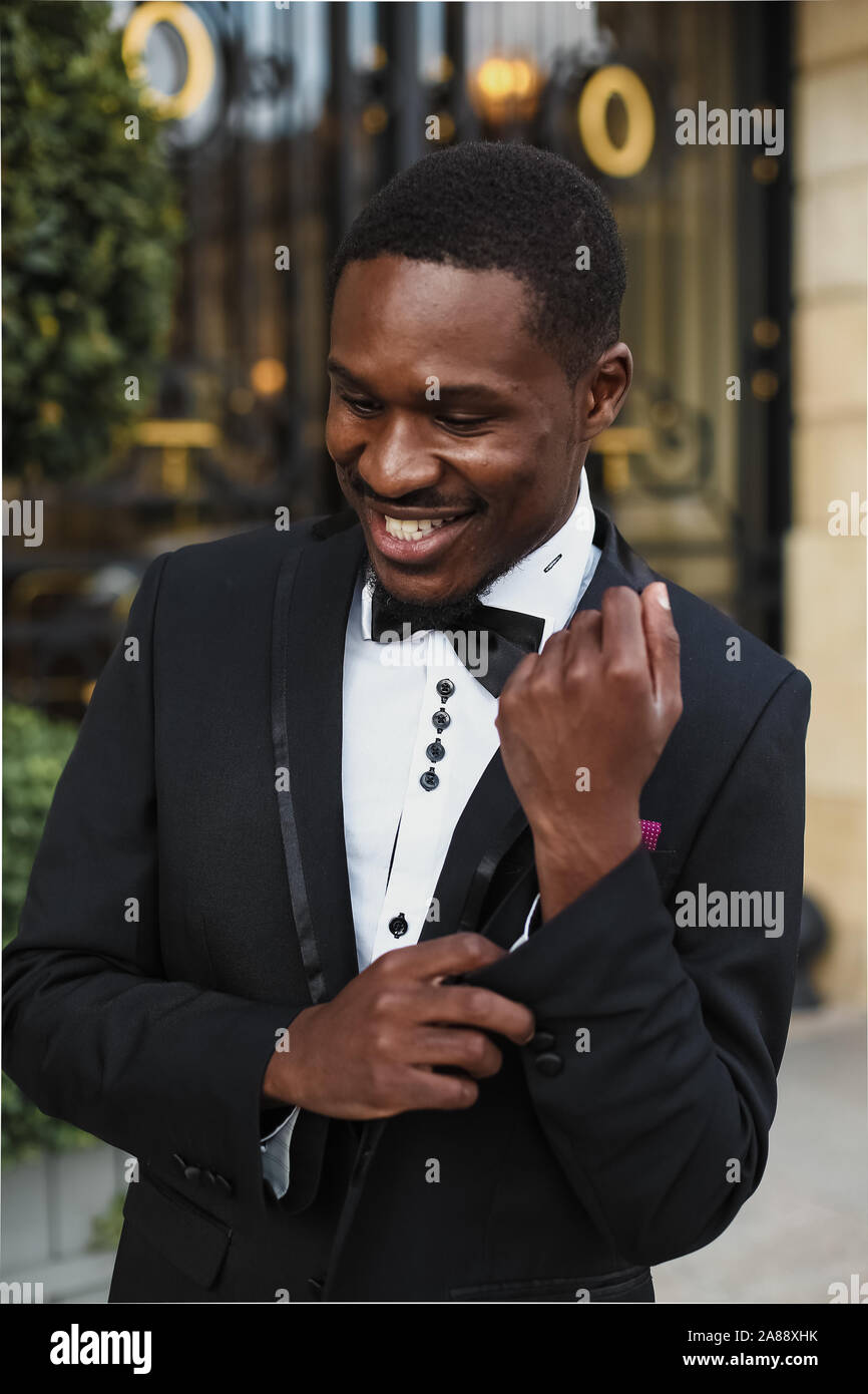 Afro american happy good looking man wearing suit and smiling outdoors ...