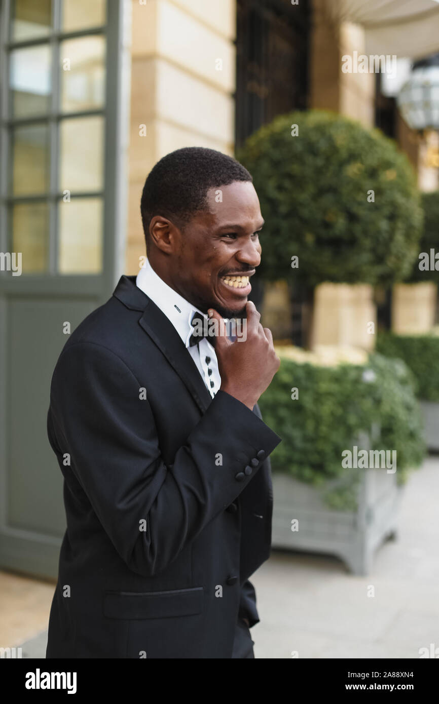 Afro american happy good looking man wearing suit and smiling outdoors ...