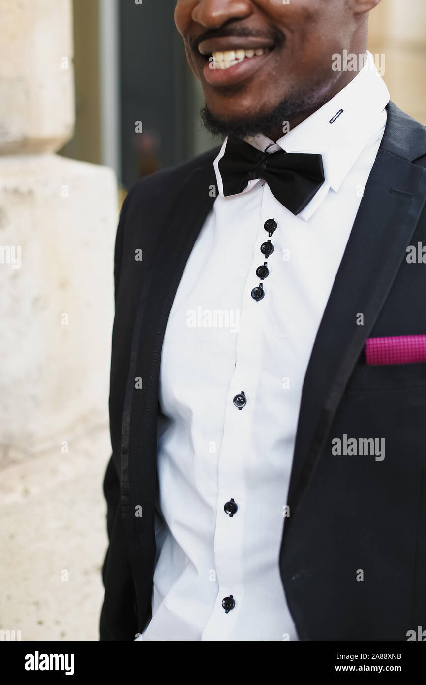 Afro american happy good looking man wearing suit and smiling outdoors ...