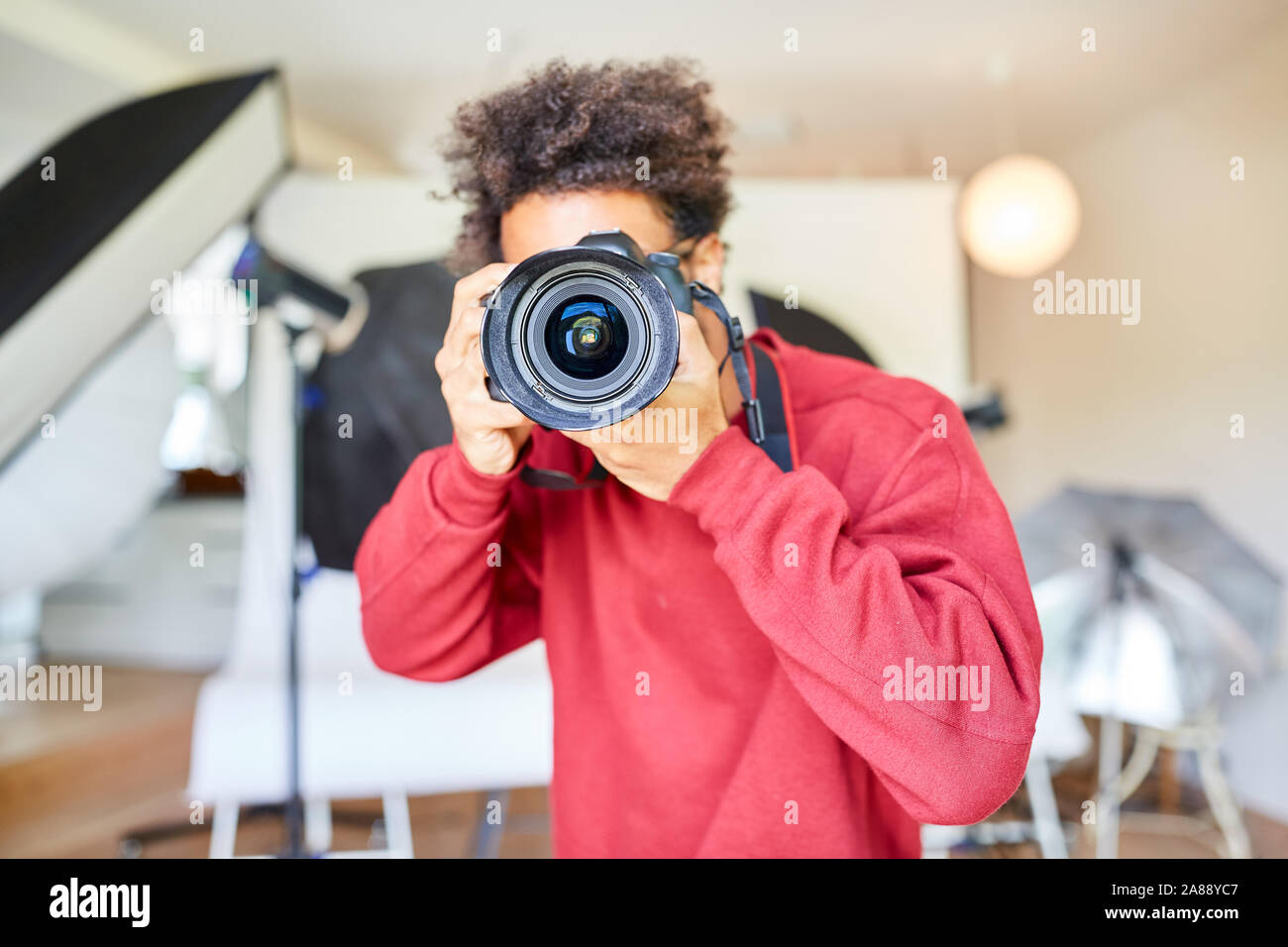 Professional photographer taking pictures with SLR camera Stock Photo