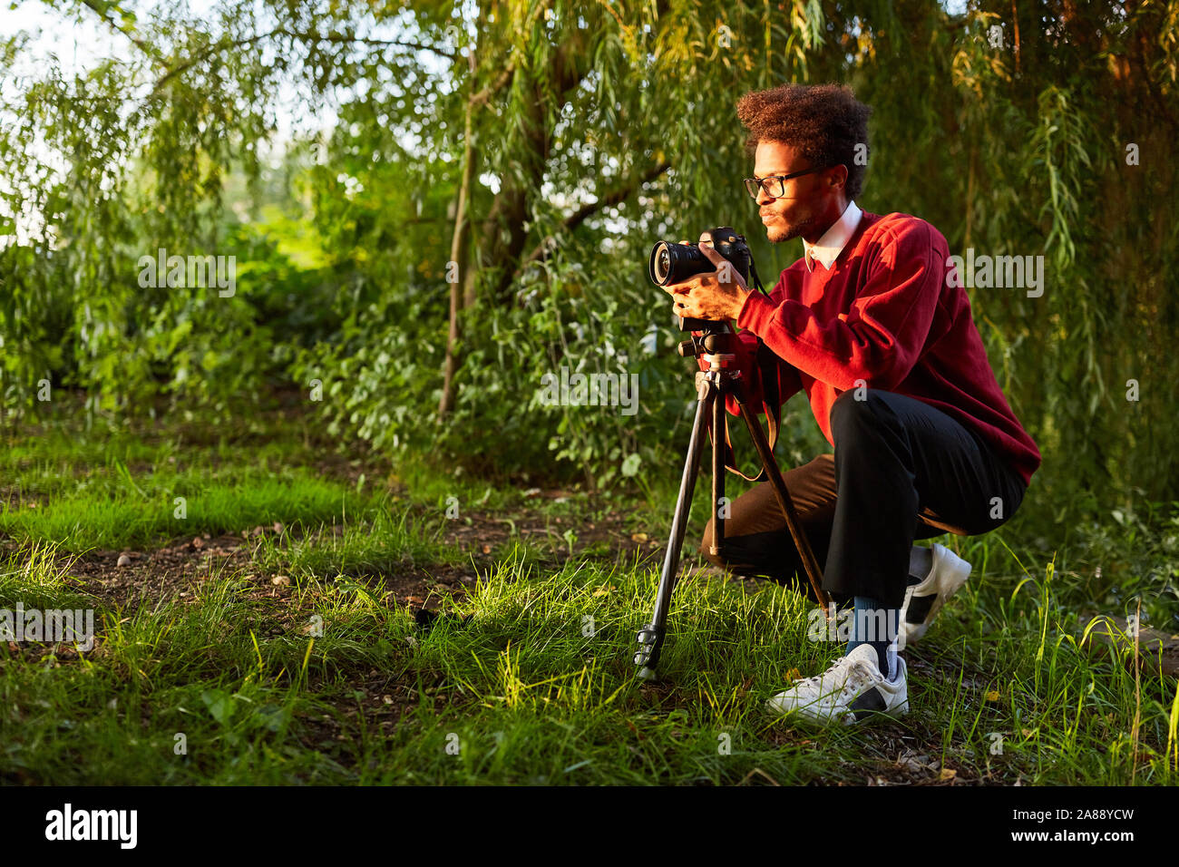 Nature photographer in landscape photography as a hobby with camera and ...