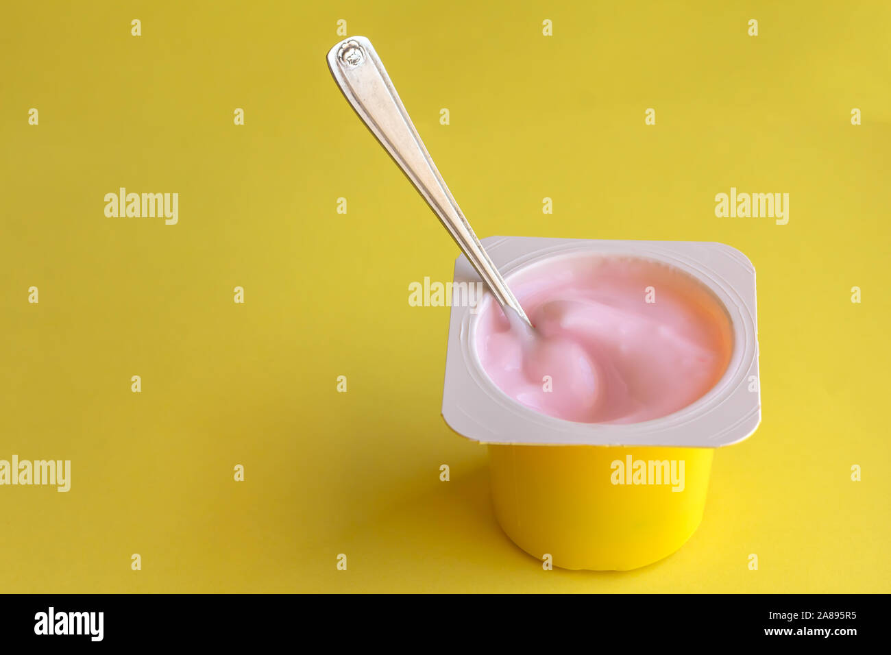 Download Strawberrry Pink Yogurt In Yellow Plastic Cup With Spoon Isolated On Bright Yellow Background With Space For Text Stock Photo Alamy Yellowimages Mockups