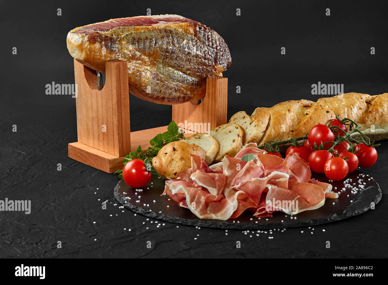 Spanish Jamon Serrano, tabla jamonera, jamonero knife with glass and bottle  of wine. Food photo concept Stock Photo - Alamy