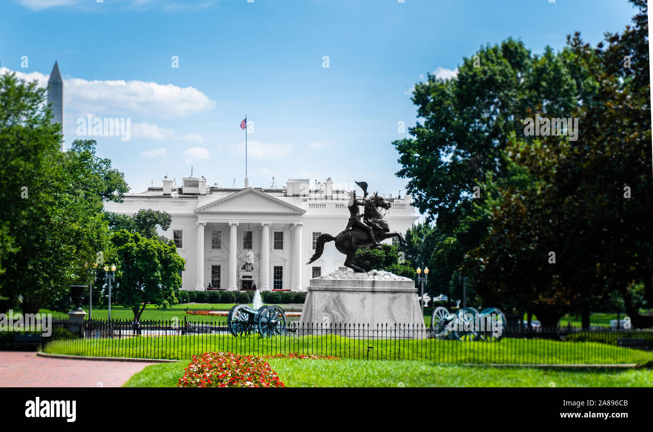 White house behind trees with blue sky and clouds above Stock Photo - Alamy