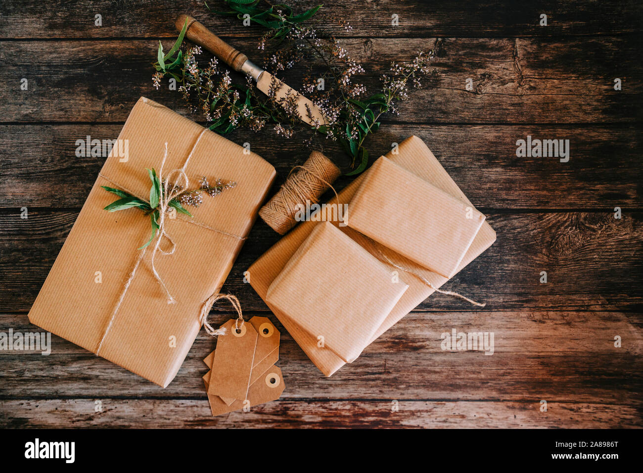 Presents wrapped in brown paper and string with labels and flowers