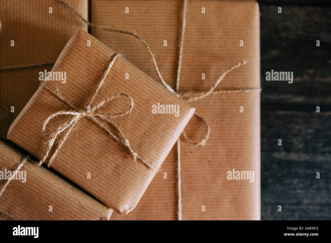 Presents wrapped in brown paper and string Stock Photo