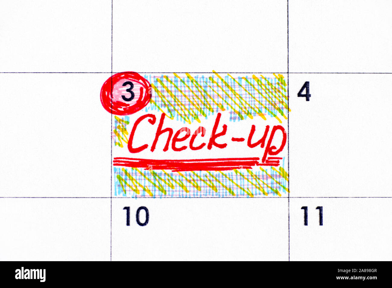 Handwriting reminder Check-up in calendar. Close-up. Stock Photo