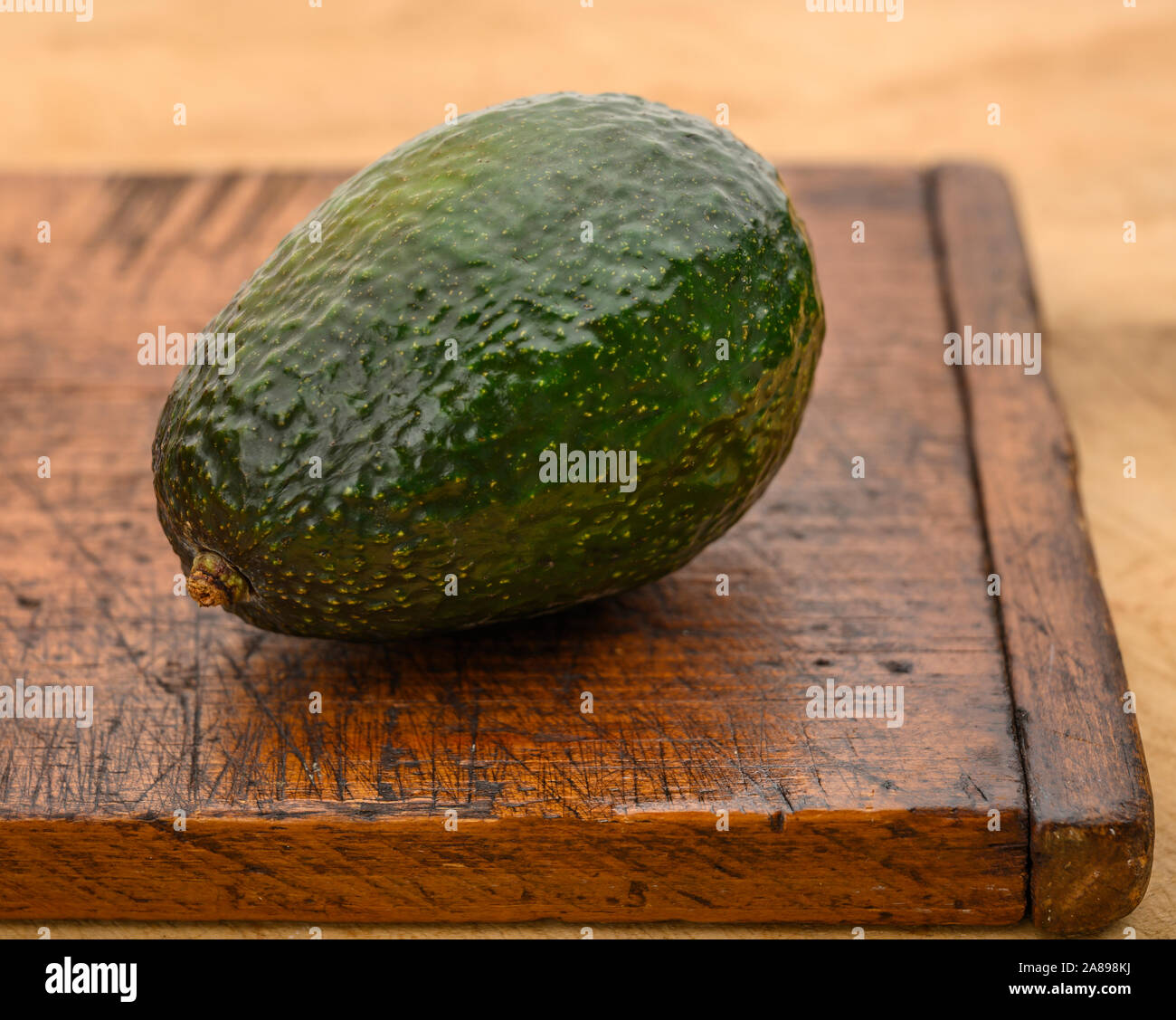 Avocados on cutting board Stock Photo