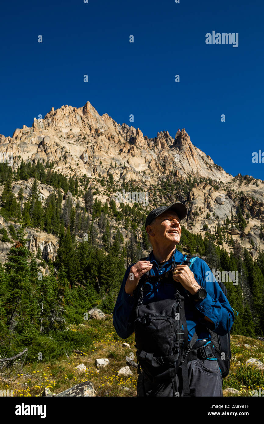 Smiling man hiking on Sawtooth Mountains in Stanley, Idaho, USA Stock Photo