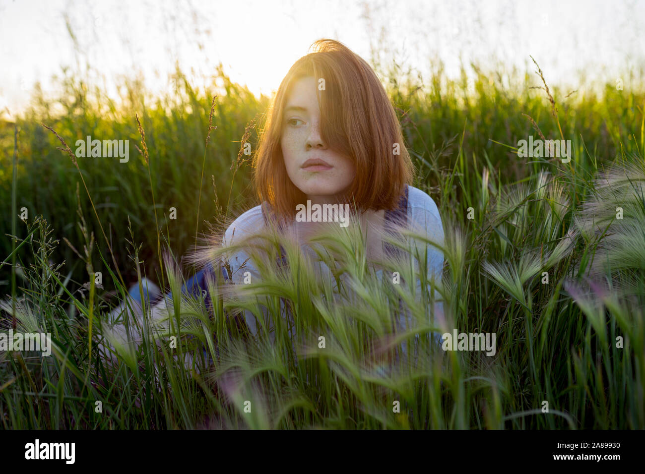 Young woman lying in wheat field Stock Photo - Alamy