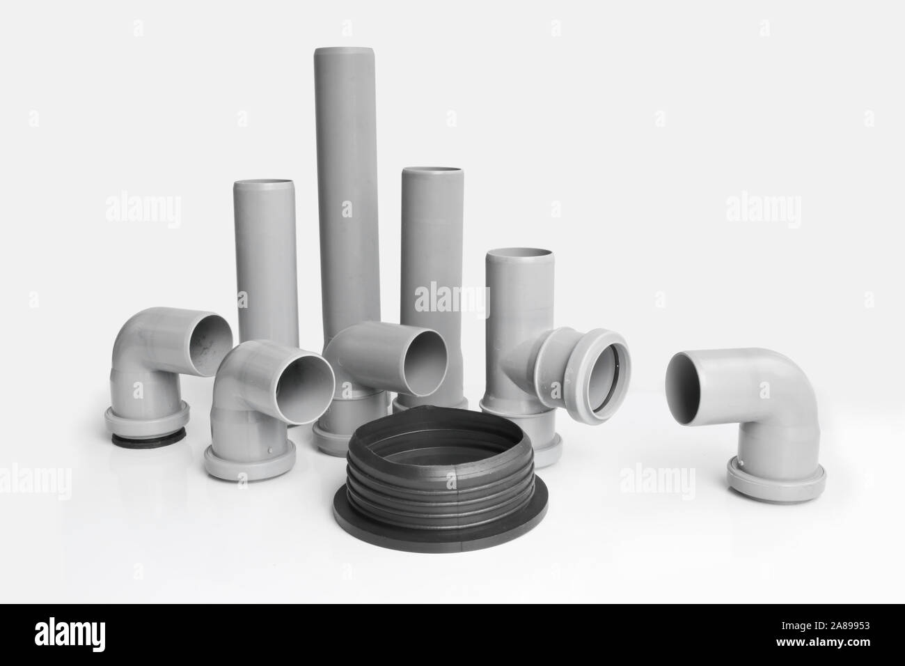 Plastic PVC pipes sewer fittings on a light background. Stock Photo