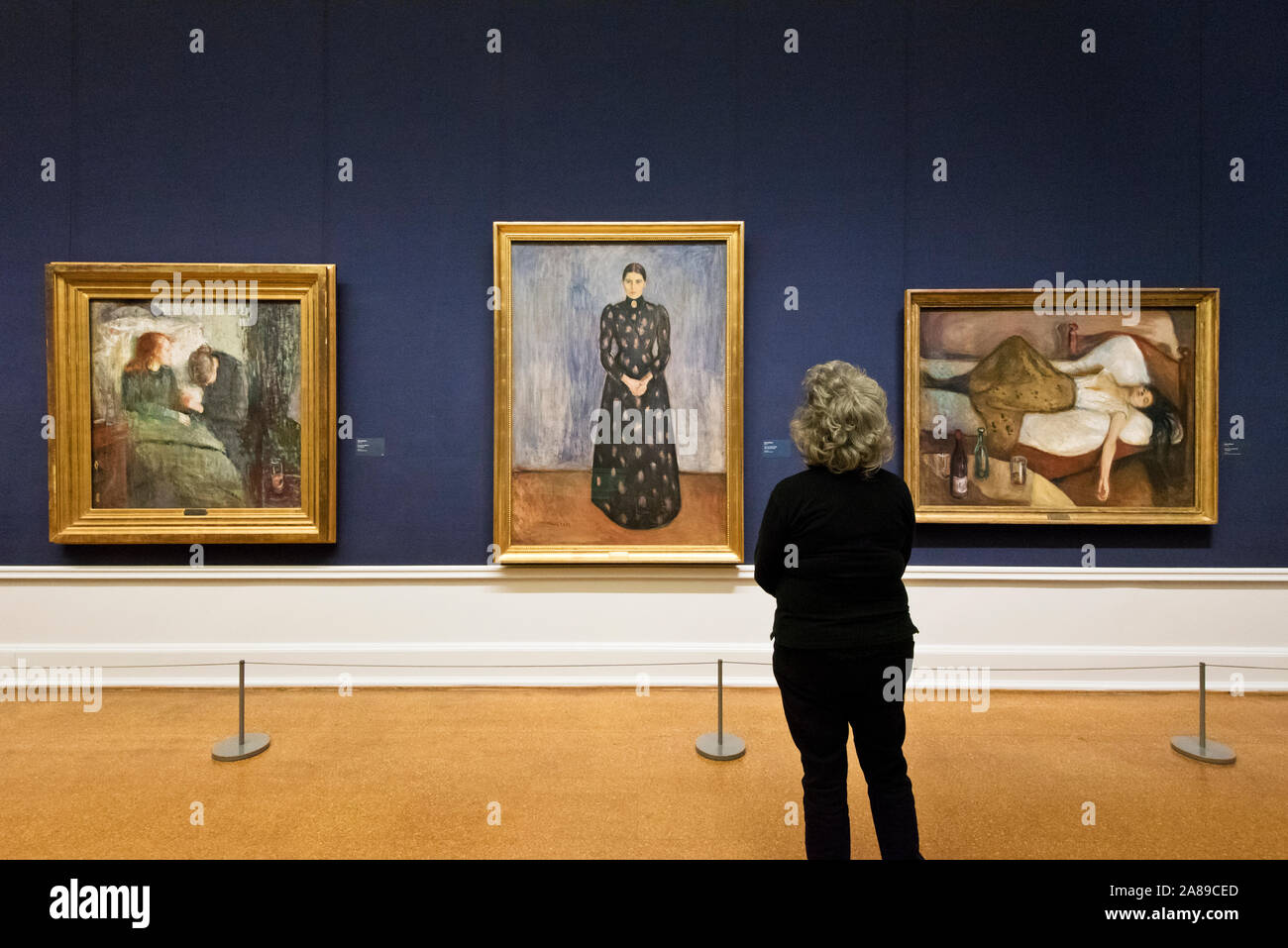 Visitor admiring the paintings by Edvard Munch. National Gallery (Nasjonalmuseet) in Oslo. Norway Stock Photo
