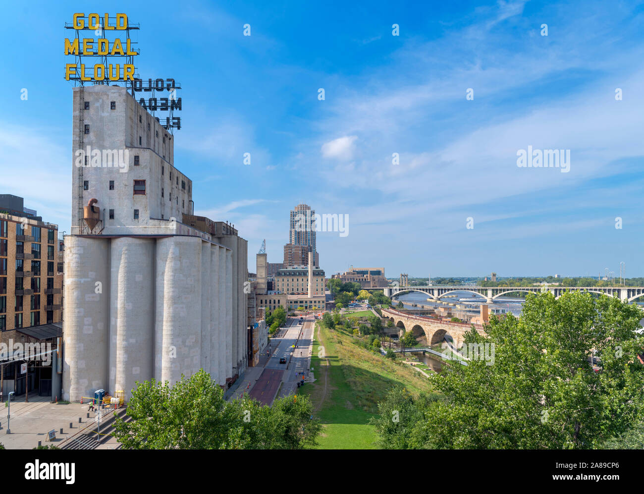View of Mississippi riverfront from Endless Bridge with Washburn A Mill (Mill Museum) and Gold Medal Flour sign to left, Minneapolis, Minnesota, USA Stock Photo