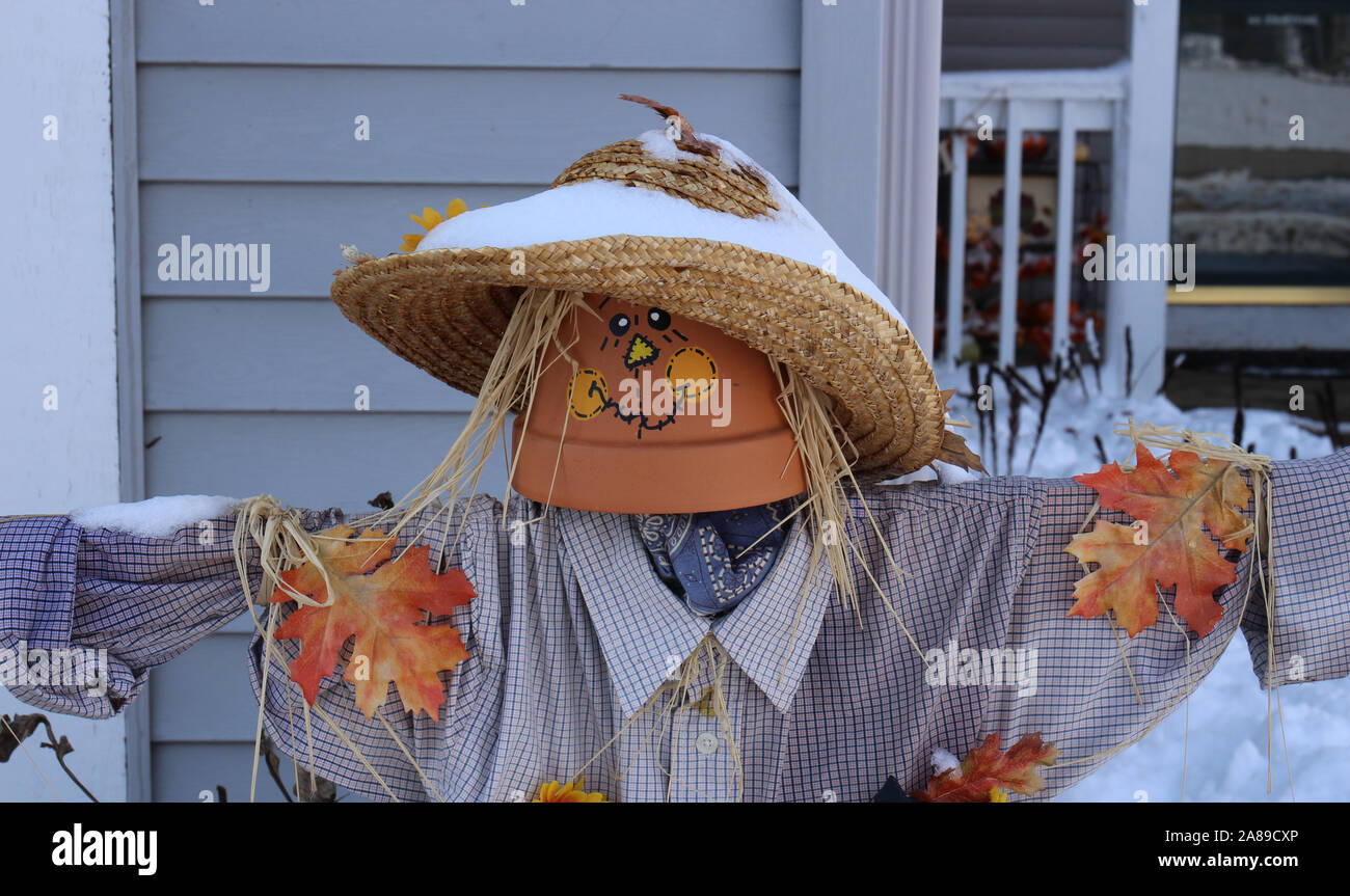 A Homemade Scarecrow Covered In Snow Decorating A Home S Front