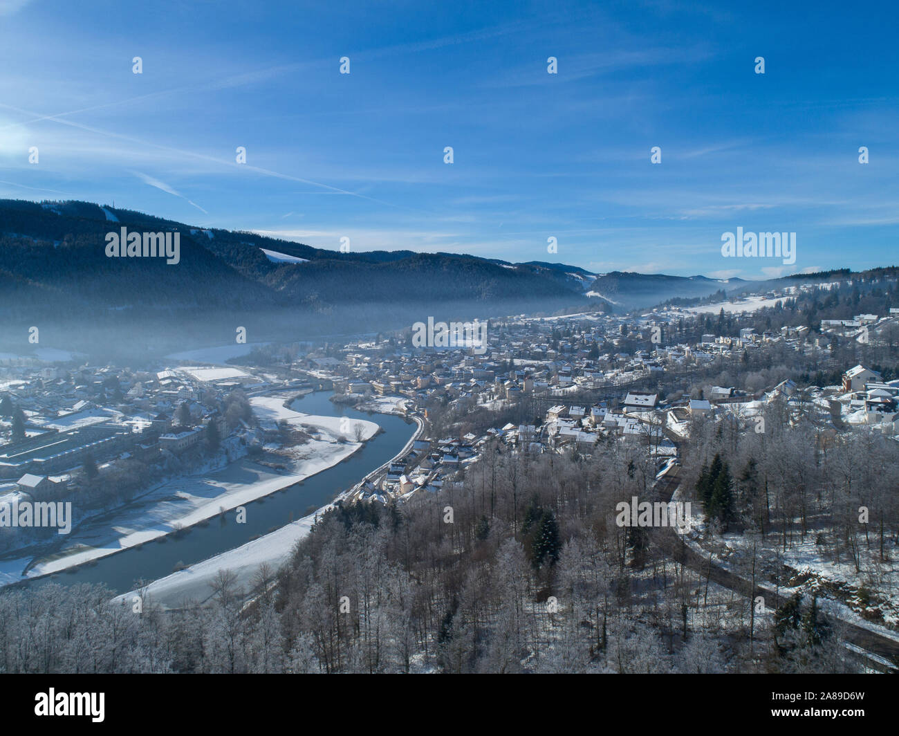 Aerial view of Villers-le-Lac in winter, in the Jura mountain range. In the middle, the River Doubs Stock Photo