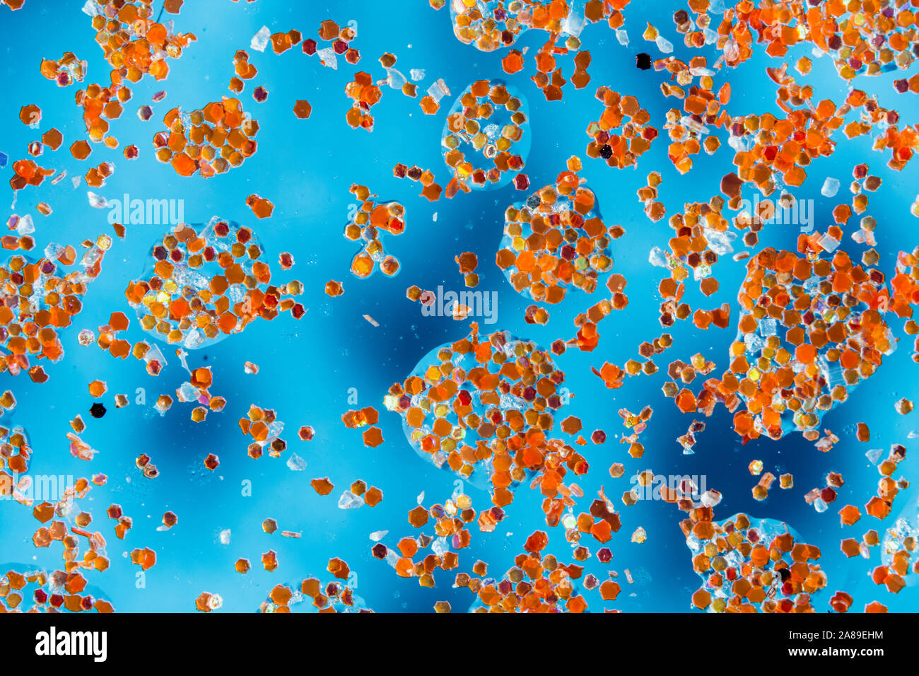 abstract blue background with water drops on glass and glitter ...