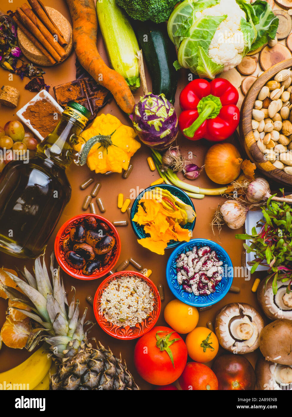 Mixed colorful foods as nuts, fruits, vegetables, beans, herbs, powders