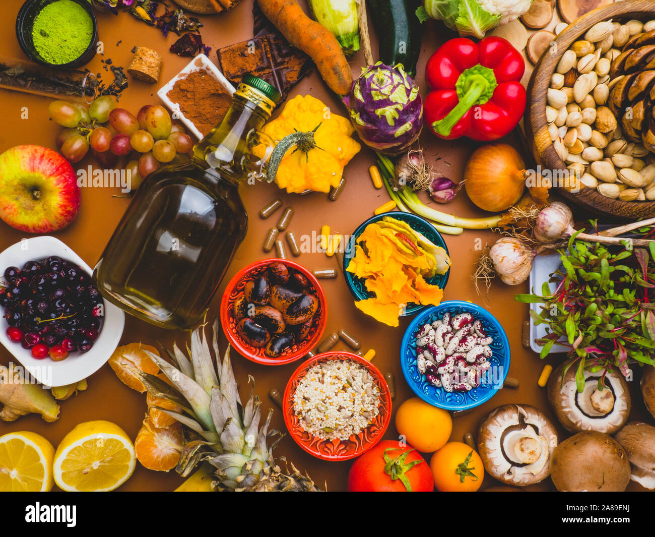 Mixed colorful foods as nuts, fruits, vegetables, beans, herbs, powders