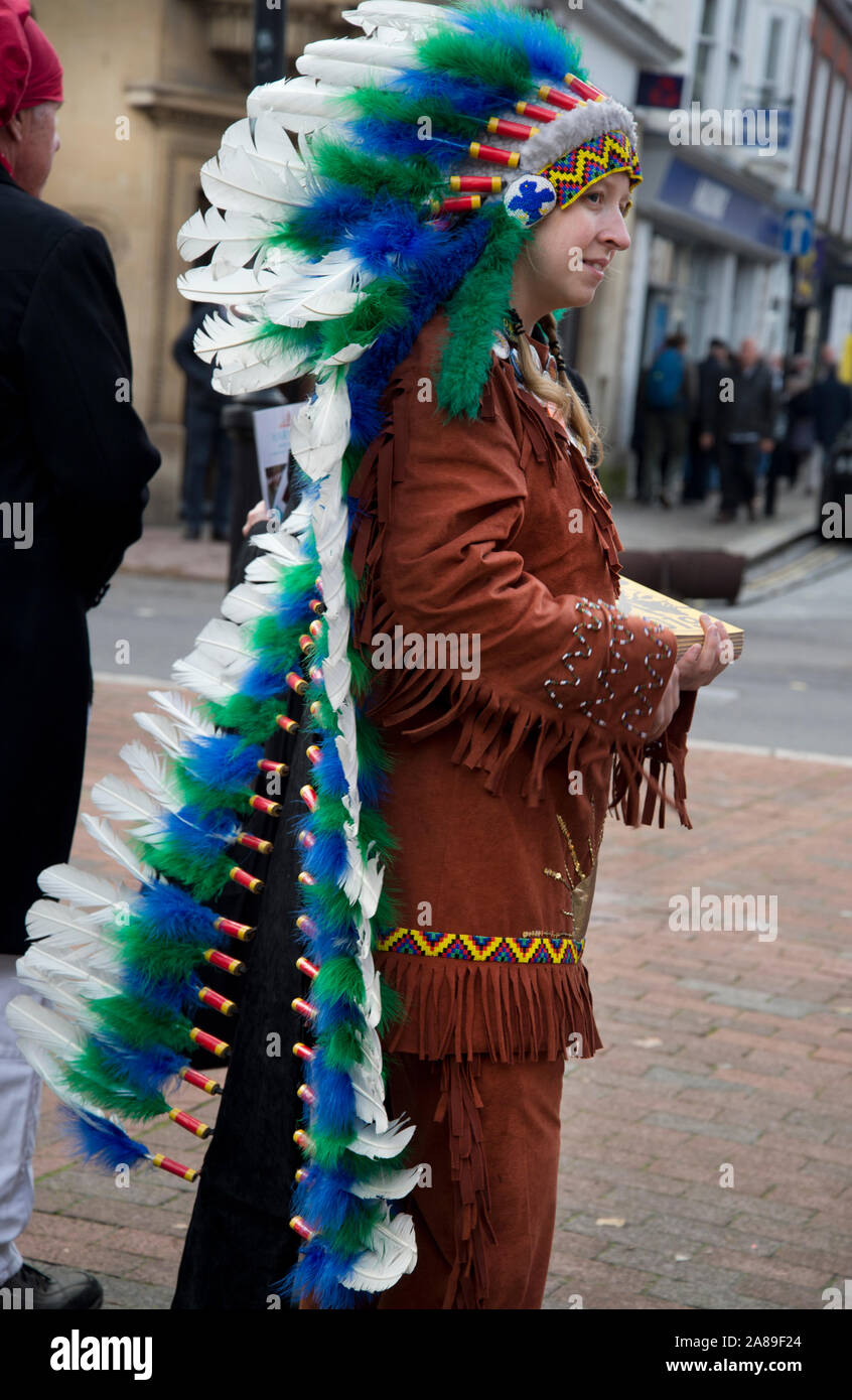 November 5th 2019. Bonfire Night, Lewes, Sussex. Programme seller in fancy dress- native American feather head dress; Stock Photo