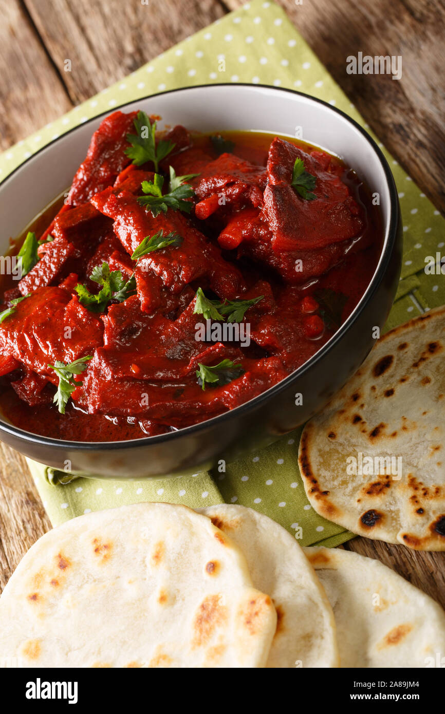 Rajasthani Jungli Maas is a traditional Indian meat dish served with roti close-up on the table. vertical Stock Photo