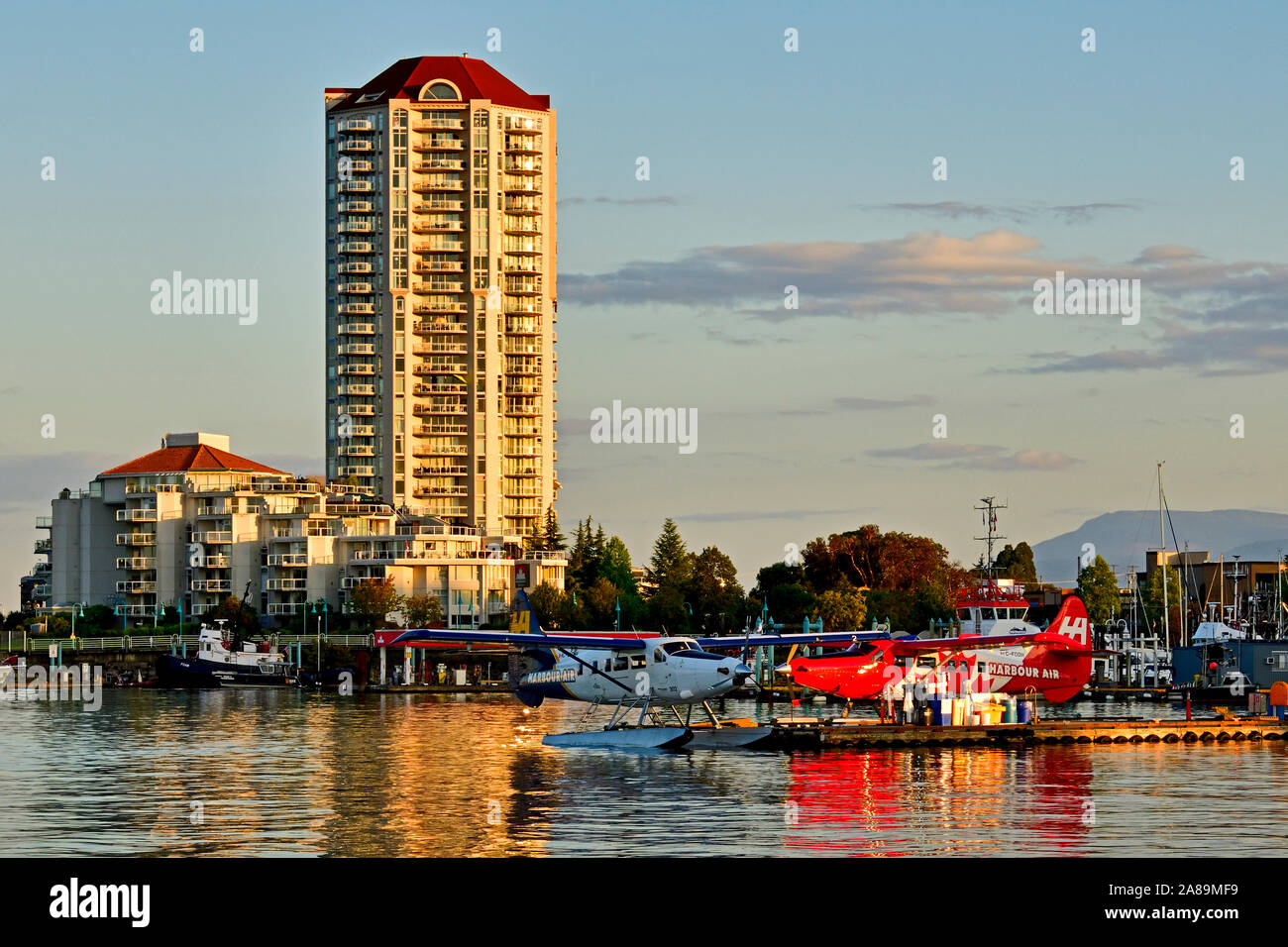A landscape view in Nanaimo harbor with the airplane dock and tall condo buildings in the background Stock Photo