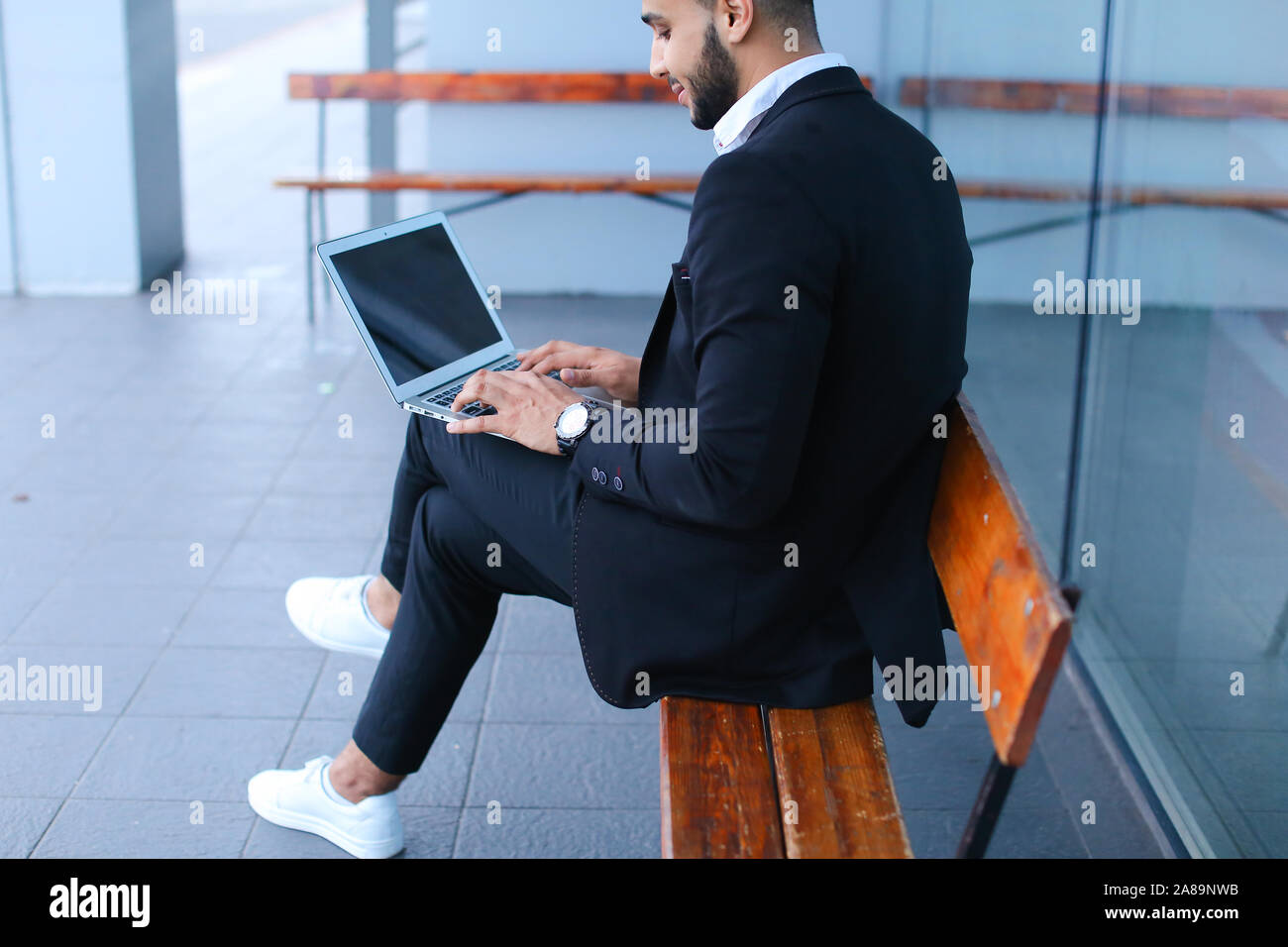 Cool guy arabic man uses laptop business center Stock Photo