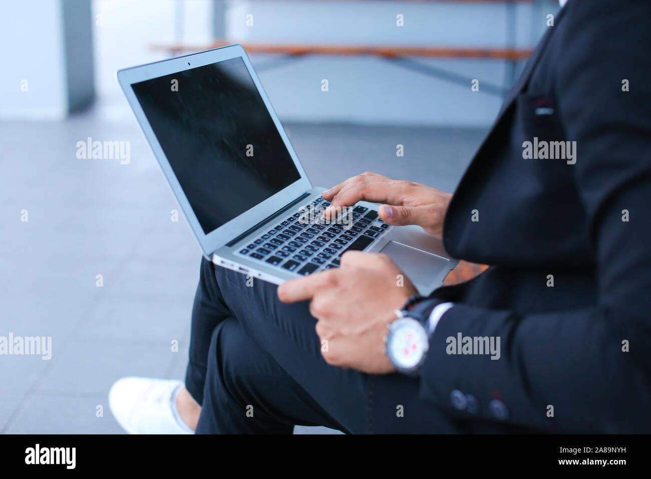 Cool guy arabic man uses laptop business center Stock Photo