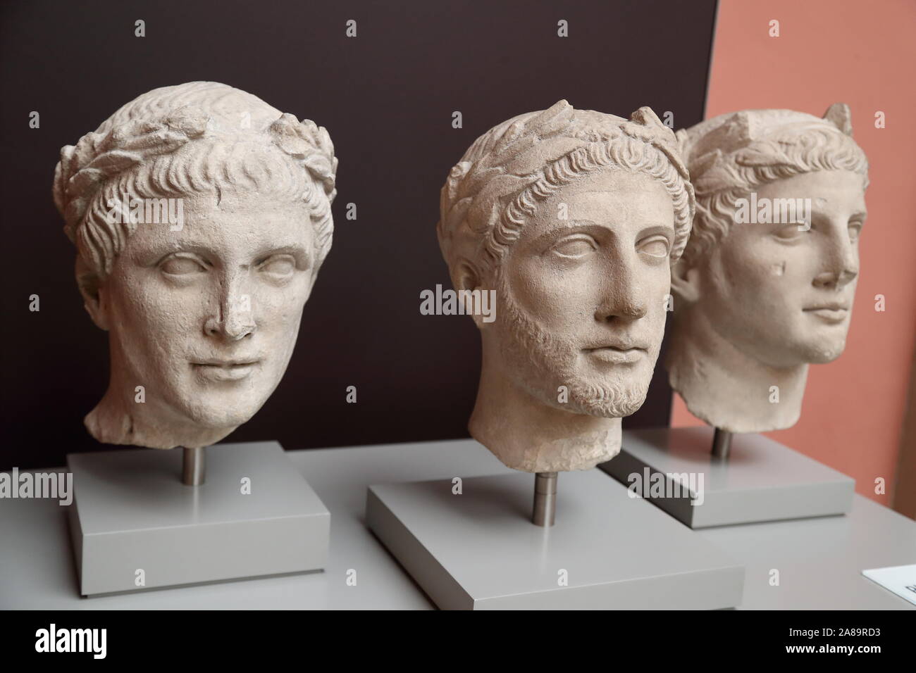 Three Cypriot sculptures of male heads in Greek style at the British Museum, London, UK Stock Photo