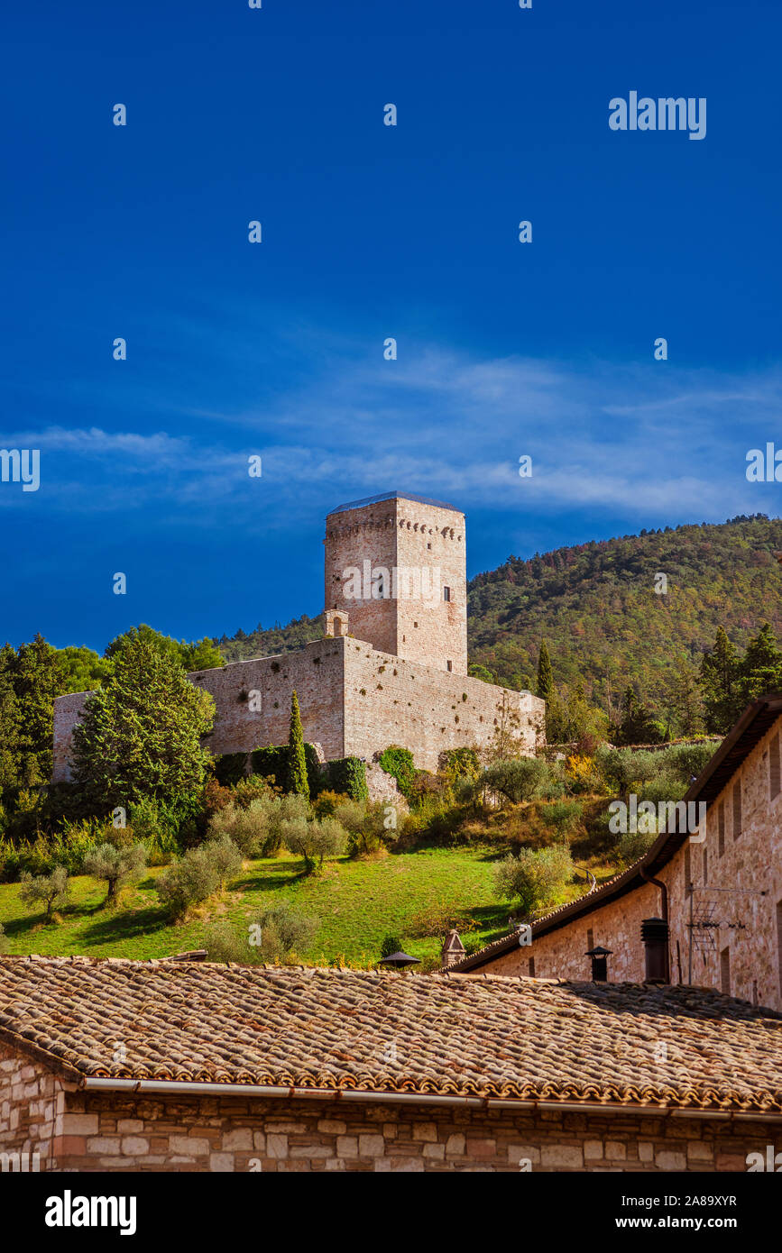 Assisi ancient medieval walls ruins at the top of the town with blue sky above Stock Photo