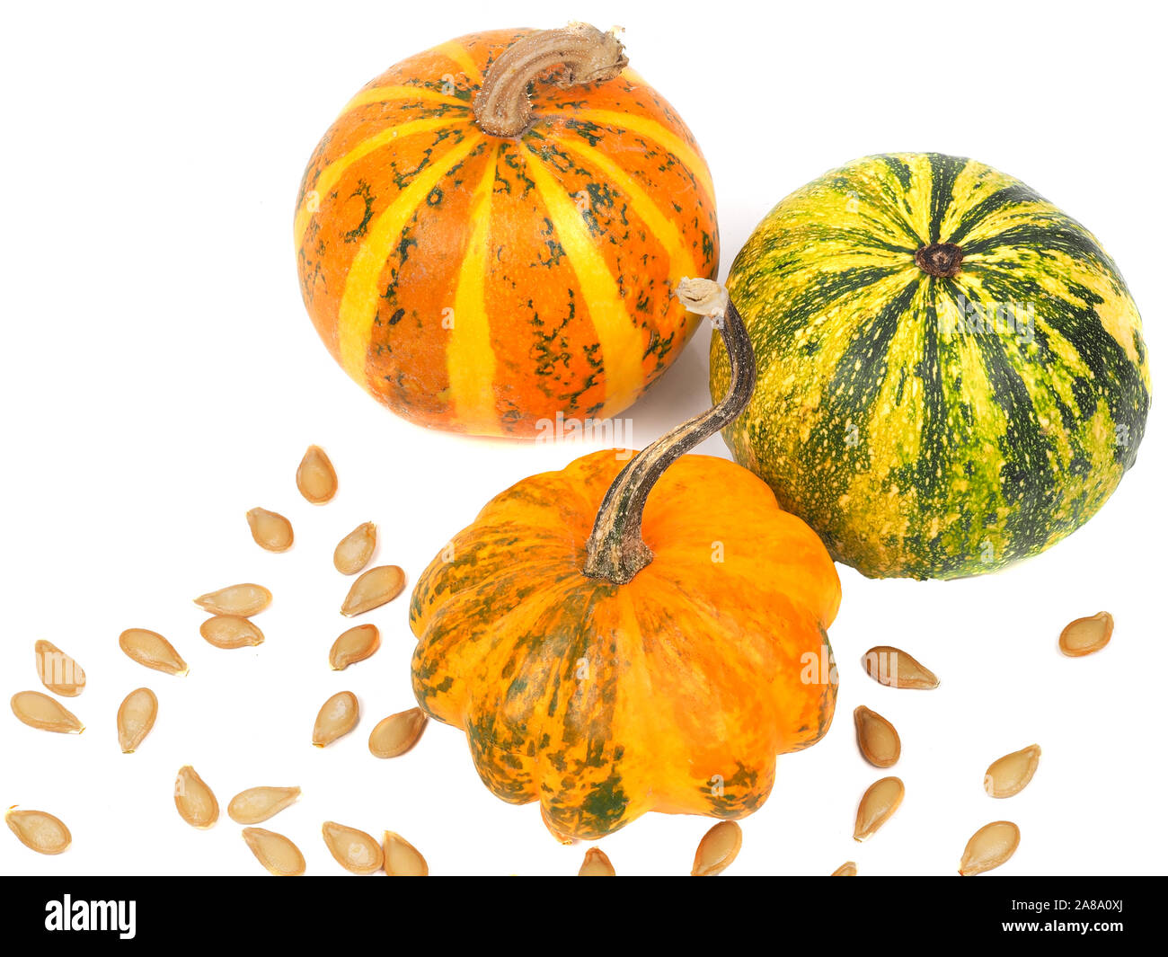 Three pumpkins with seeds isolated on white Stock Photo