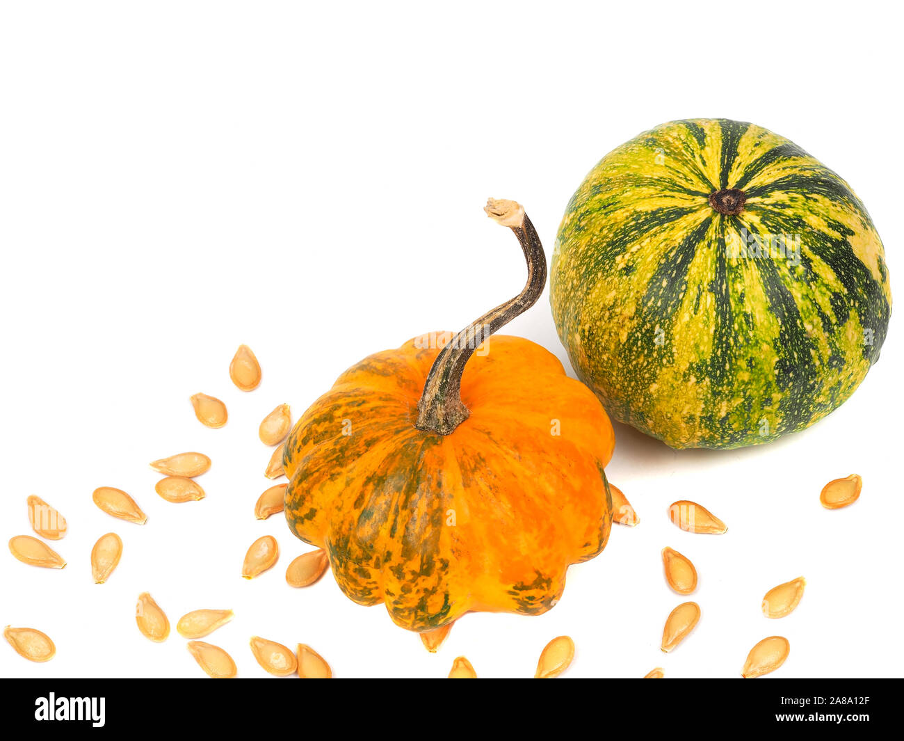 Two pumpkins with seeds isolated on white Stock Photo - Alamy