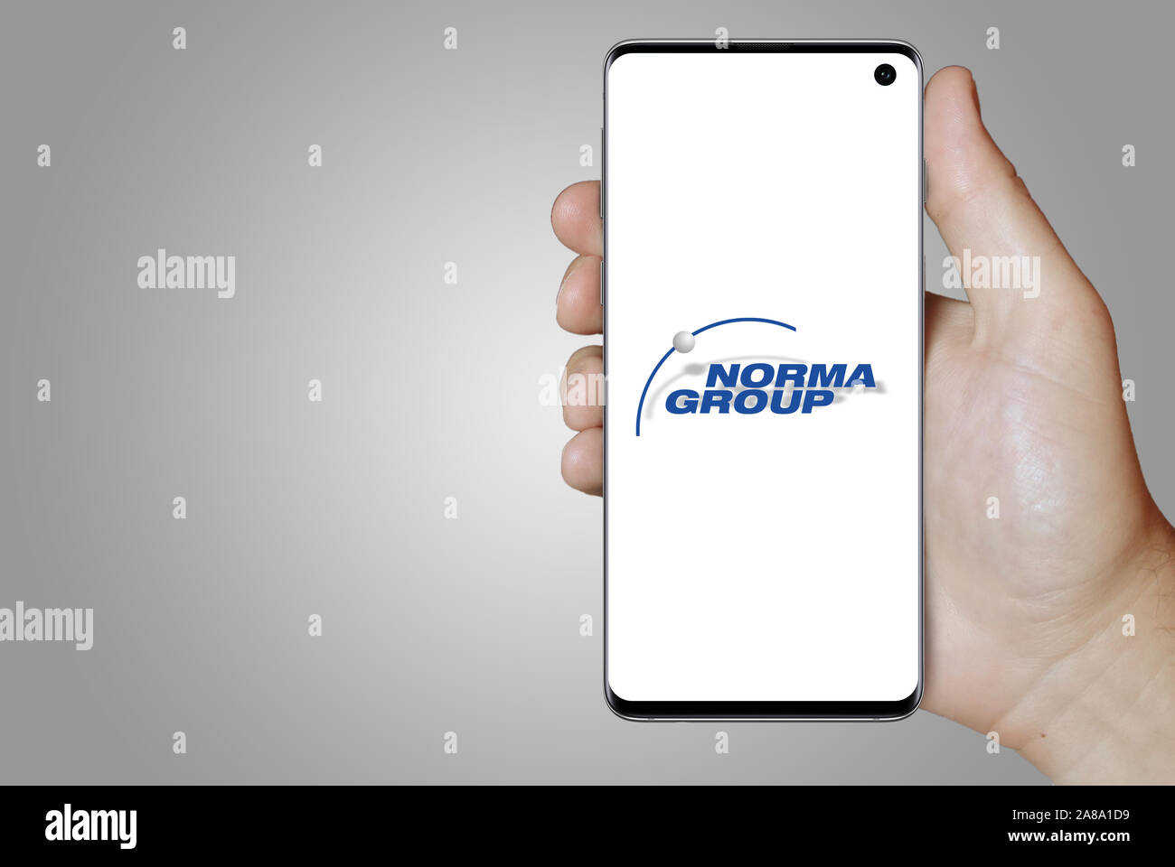 Logo of public company Norma Group displayed on a smartphone. Grey background. Credit: PIXDUCE Stock Photo