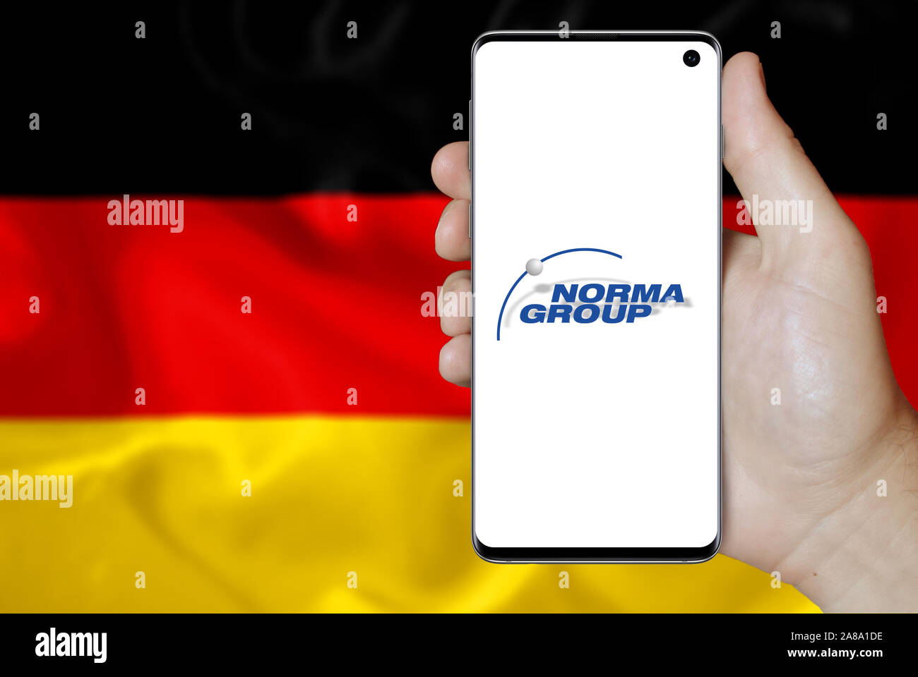 Logo of public company Norma Group displayed on a smartphone. Flag of Germany background. Credit: PIXDUCE Stock Photo