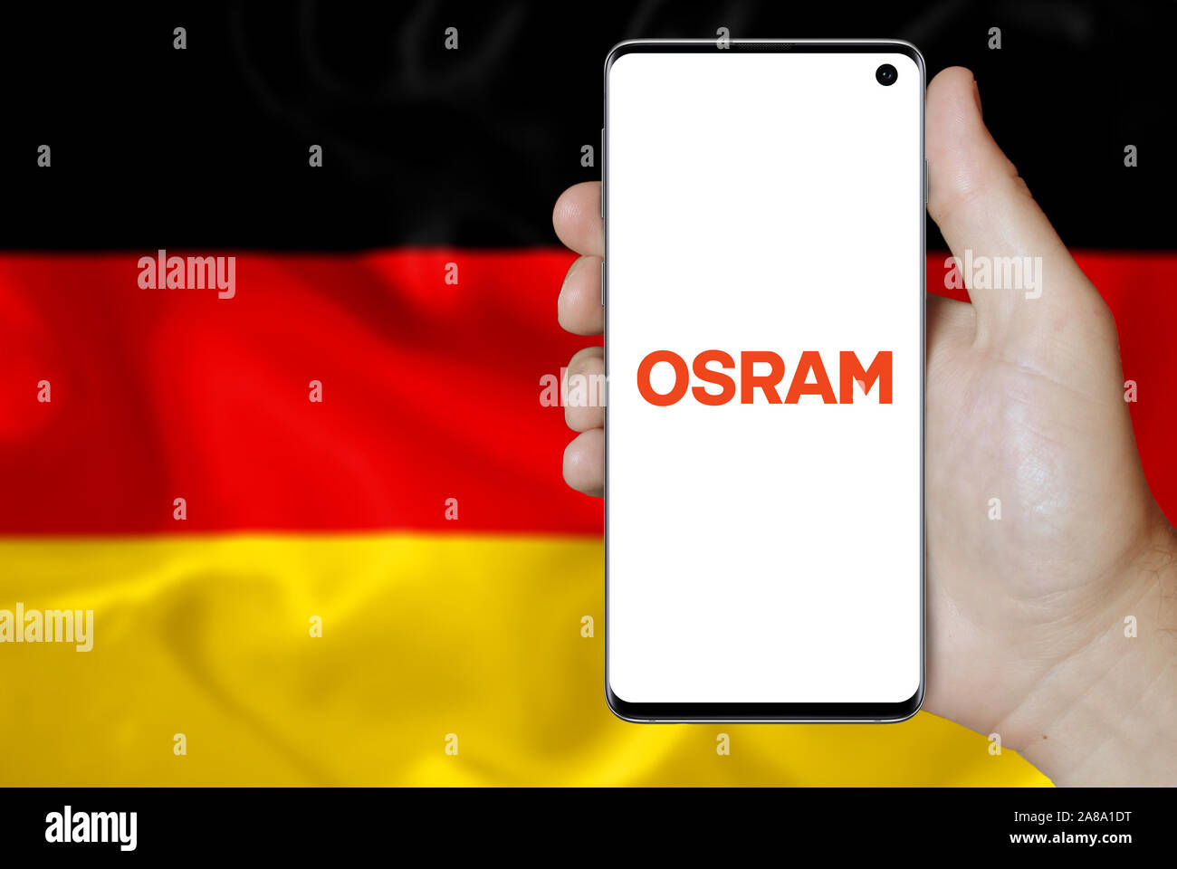 Logo of public company Osram displayed on a smartphone. Flag of Germany  background. Credit: PIXDUCE Stock Photo - Alamy