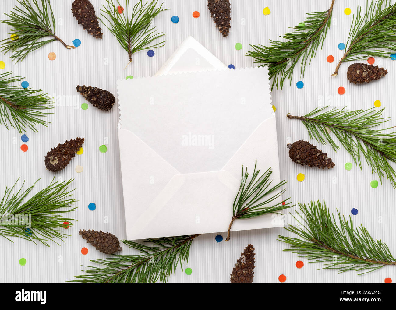 Christmas Greeting Card Letter. White paper sheet with copy space for text. Decor from pine branches and festive confetti Stock Photo
