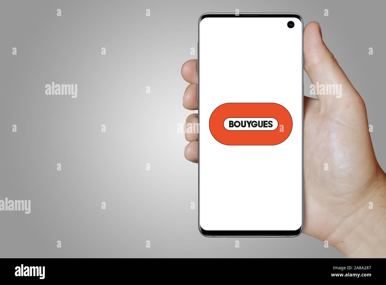Logo of public company Bouygues displayed on a smartphone. Grey background. Credit: PIXDUCE Stock Photo