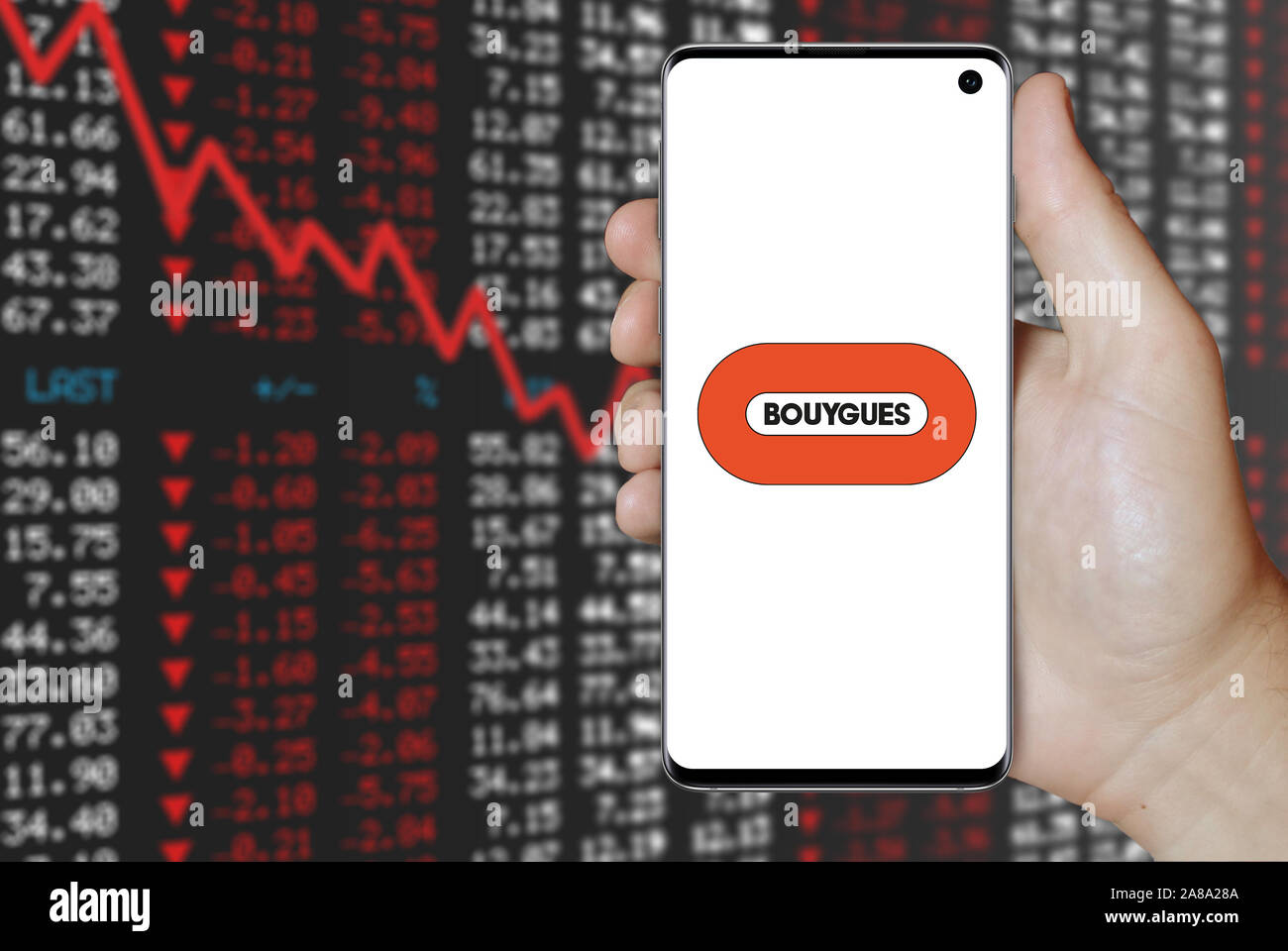 Logo of public company Bouygues displayed on a smartphone. Negative stock market background. Credit: PIXDUCE Stock Photo