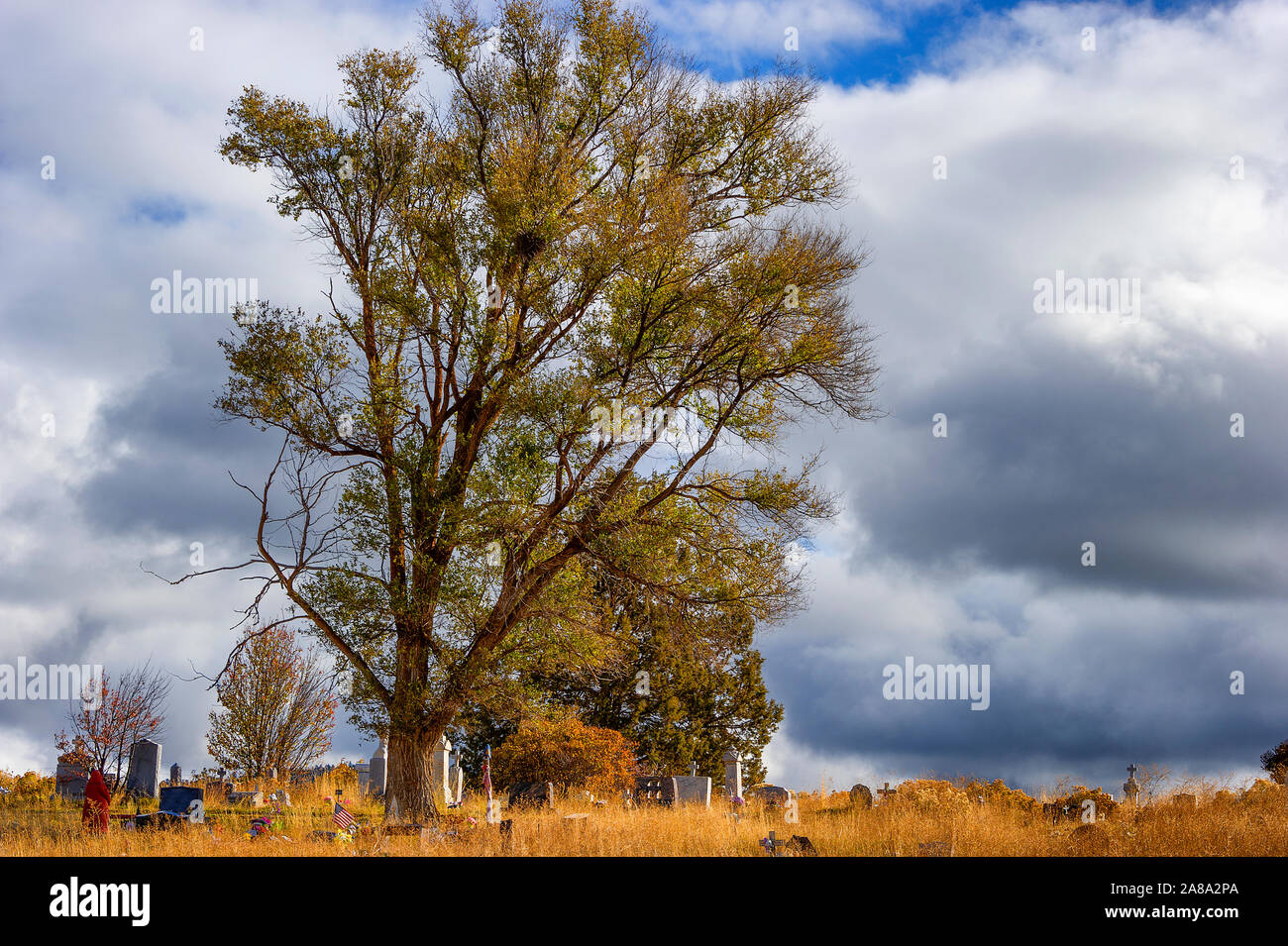 Stormy skies loom over an small cemetary on a hill in rural Oregon Stock Photo