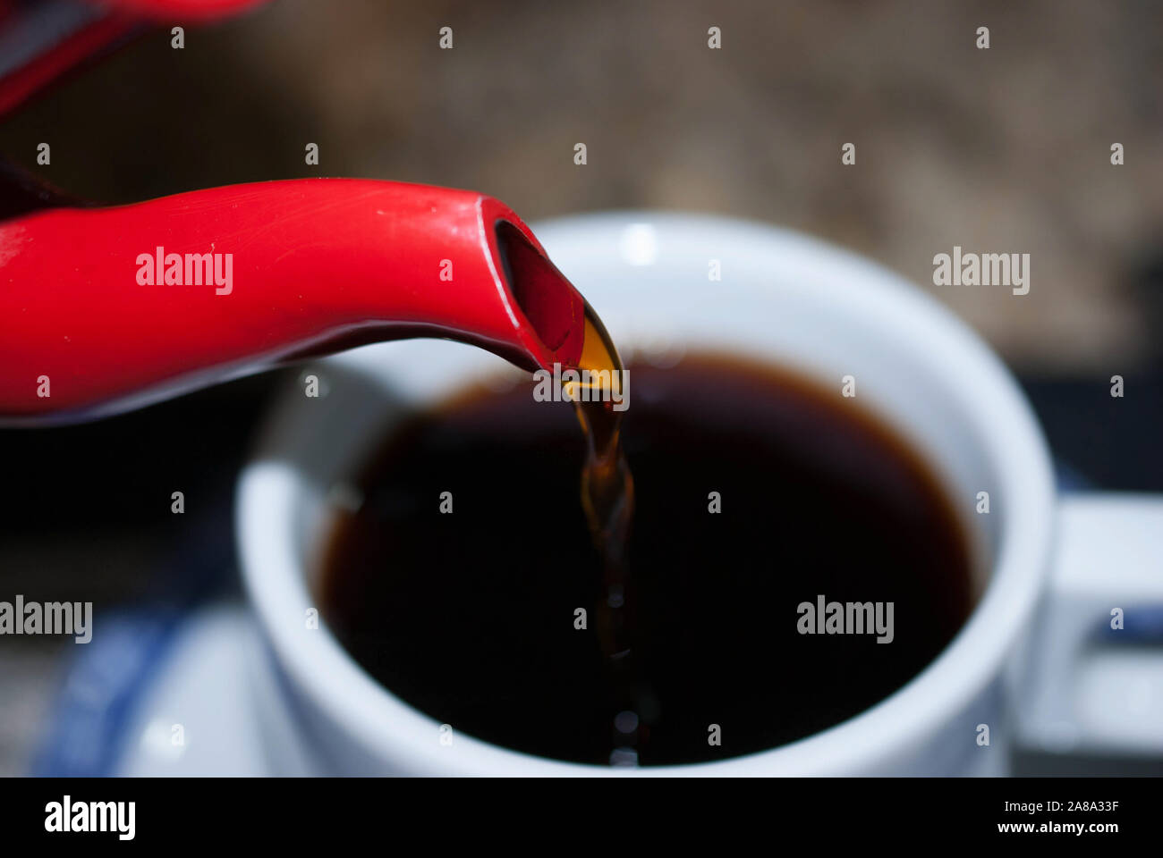 putting coffee in the white cup Stock Photo Alamy